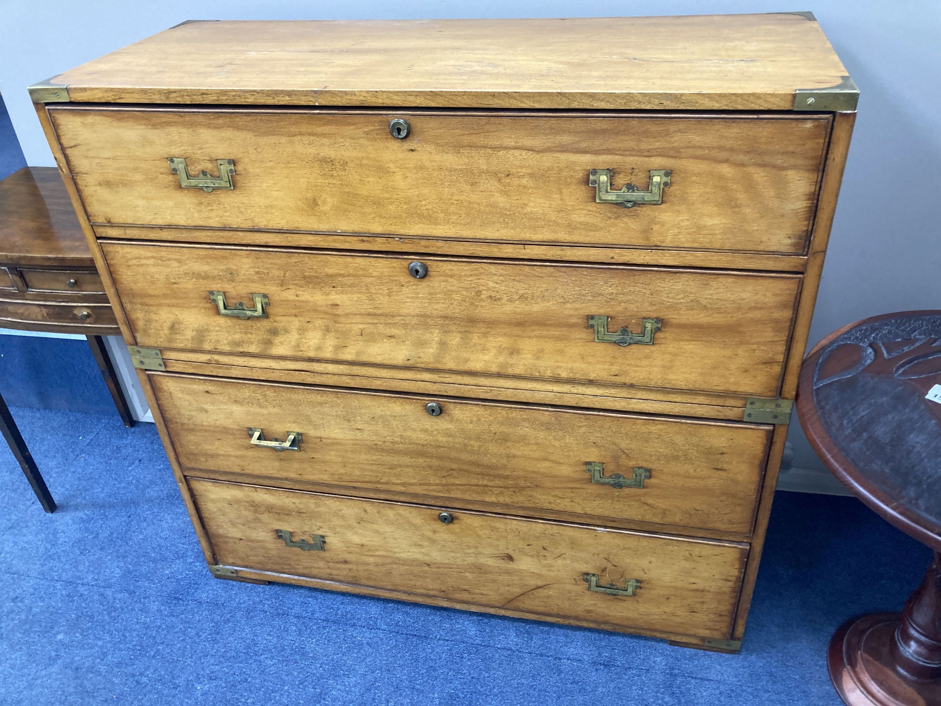 A 19th century two sectional fruitwood campaign chest, of four long drawers, brass capped with flush fitting handles and further carryi